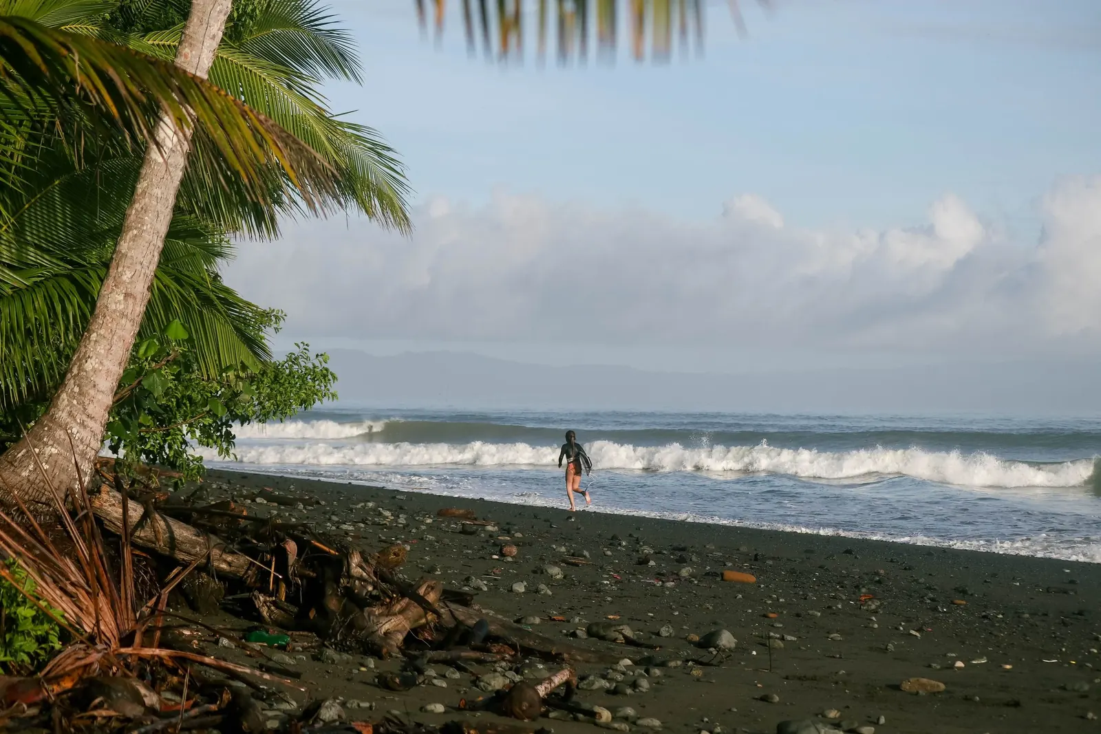 Palm trees framing the waves at Playa Hermosa