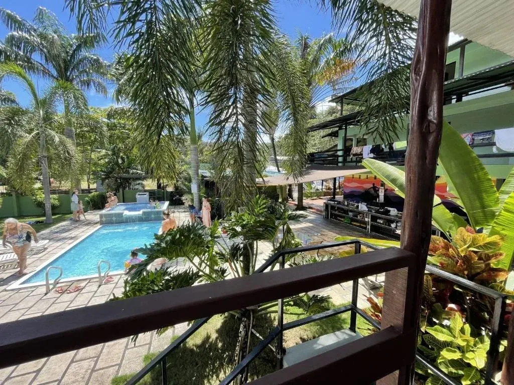 View from a balcony over the pool and gardens