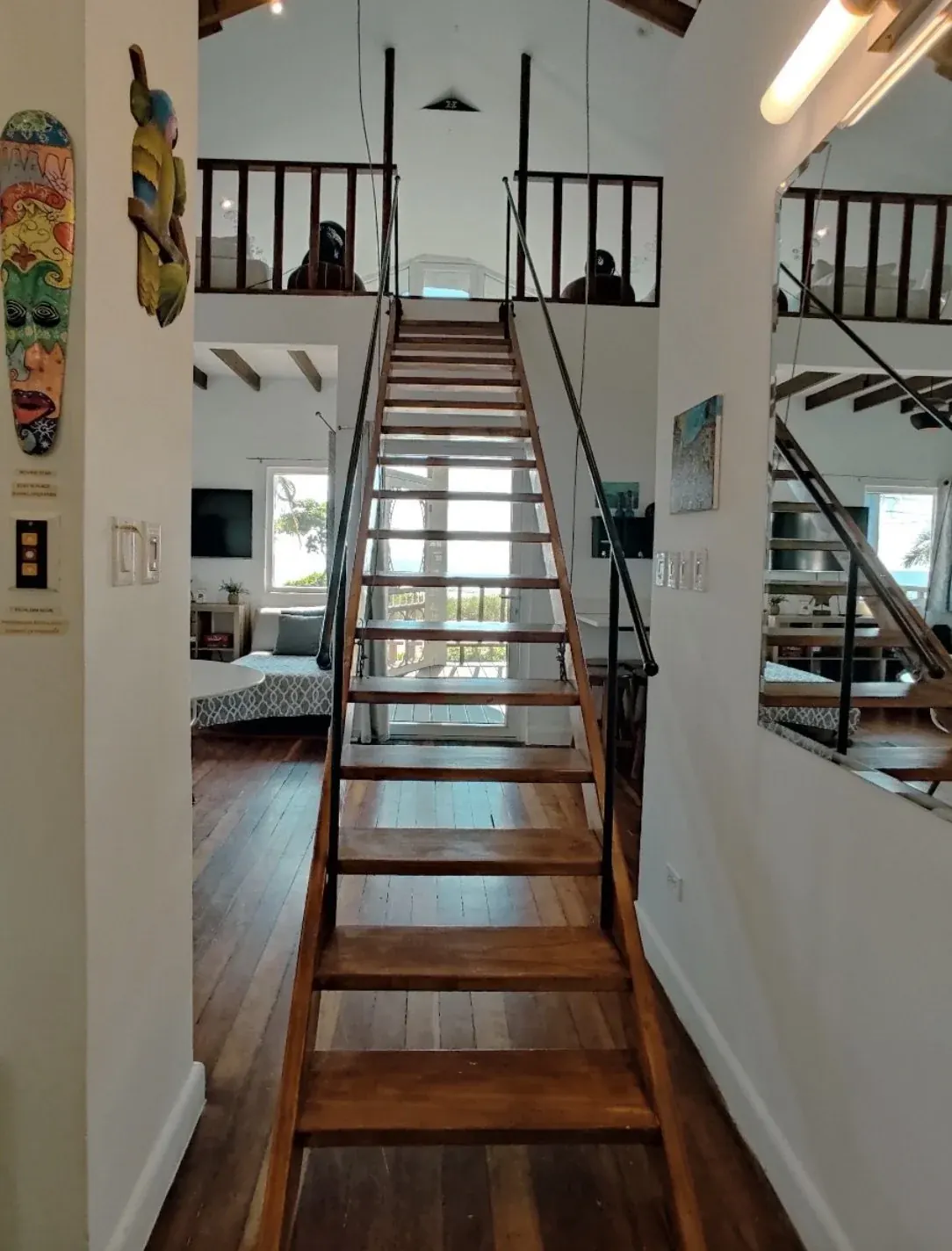 Inside a bungalow, looking up the wooden staircase
