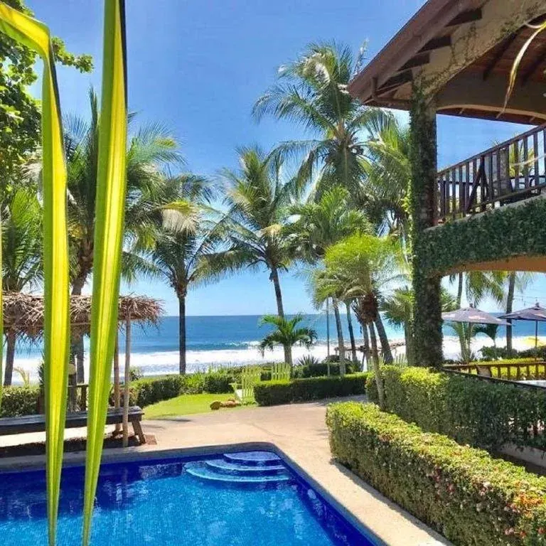 Beachfront pool and gardens with the ocean beyond